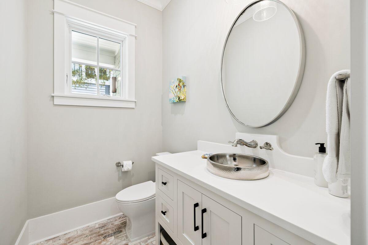 41 North Shingle Lane Watersound, FL 32461 - Photo 34 of 48 a bathroom with a granite countertop toilet sink and mirror