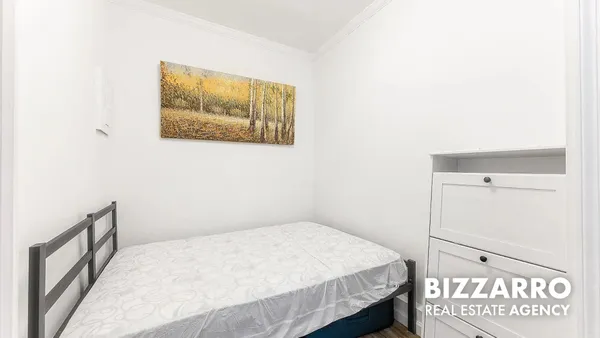 a bedroom with a bed and a wall painting