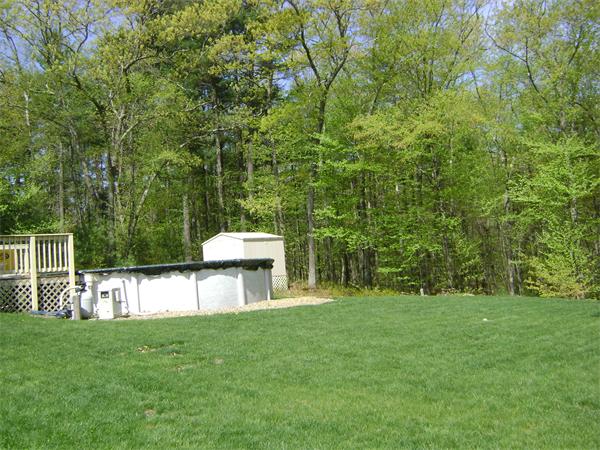 269 Hillcrest Road Northbridge, MA 01588 - Photo 16 of 16 a view of a backyard with a garden and trees
