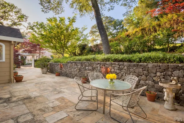 a view of a lake with couches and table under an umbrella