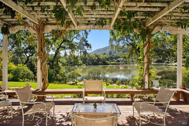 a view of a livingroom with furniture and floor to ceiling window