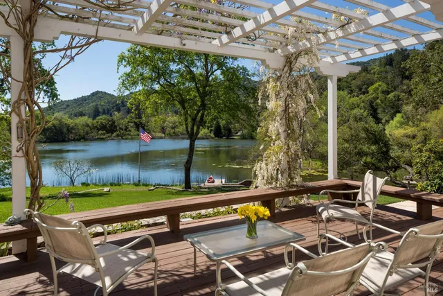 a view of a lake with a yard and a bench