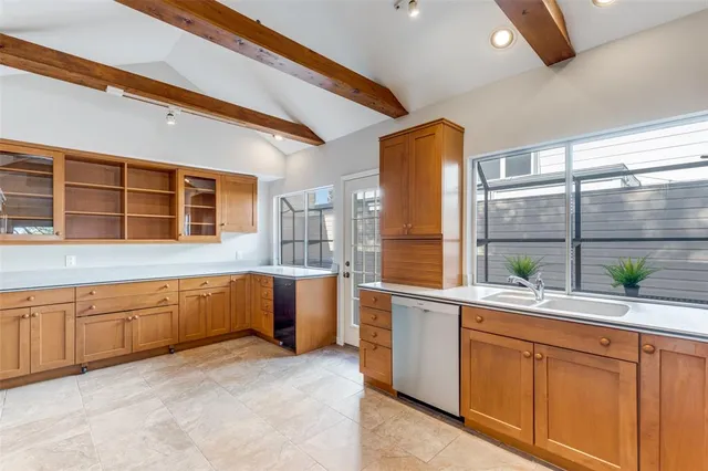 a large kitchen with stainless steel appliances granite countertop a sink and cabinets