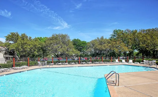 a view of a park with large trees