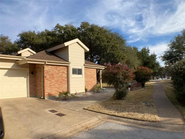 a view of a house with a yard and garage