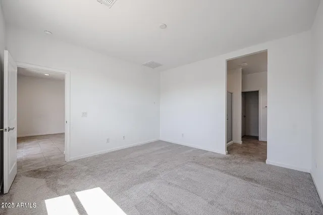 a view of an empty room and a window