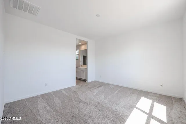 a kitchen with stainless steel appliances granite countertop a refrigerator a stove a sink a microwave and white cabinets