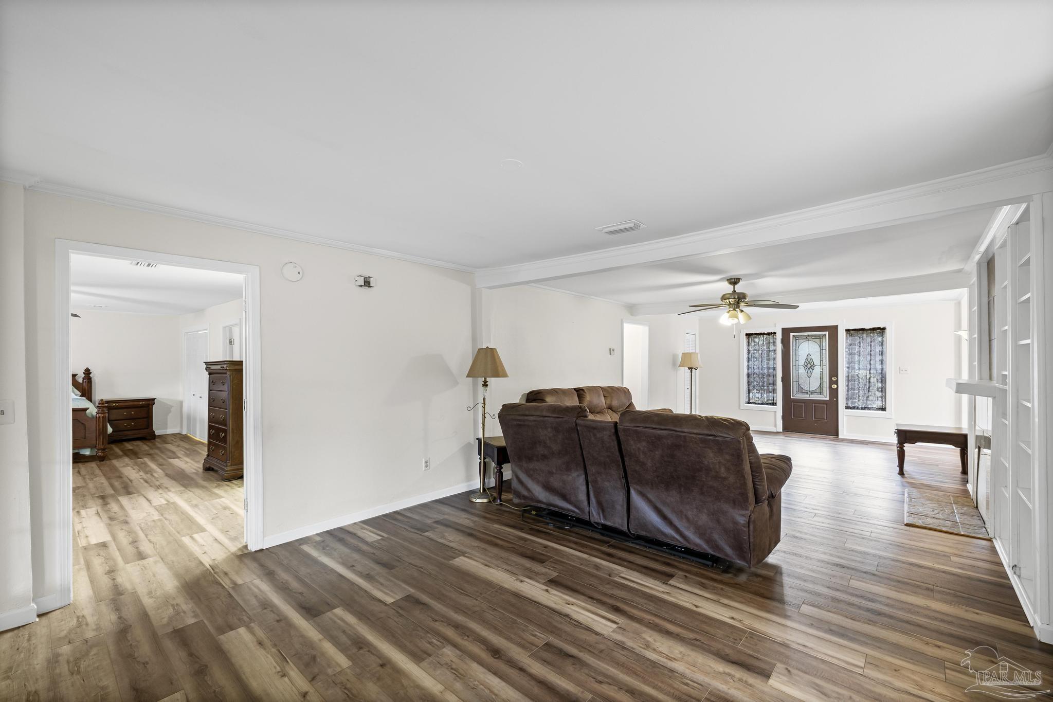 3811 Wilkes Street Pace, FL 32571 - Photo 11 of 59 a living room with furniture and a wooden floor