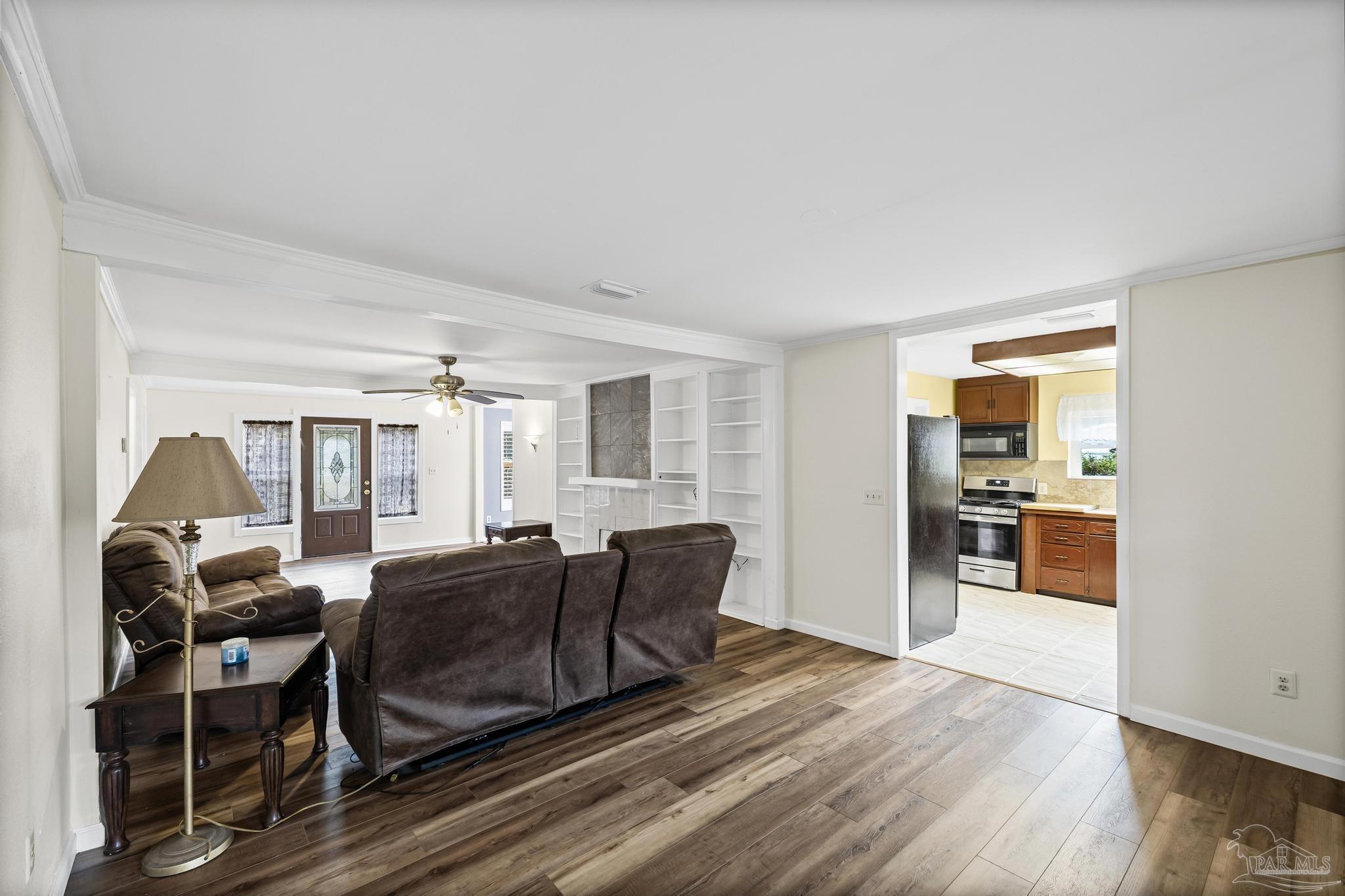 3811 Wilkes Street Pace, FL 32571 - Photo 12 of 59 a living room with furniture and wooden floor