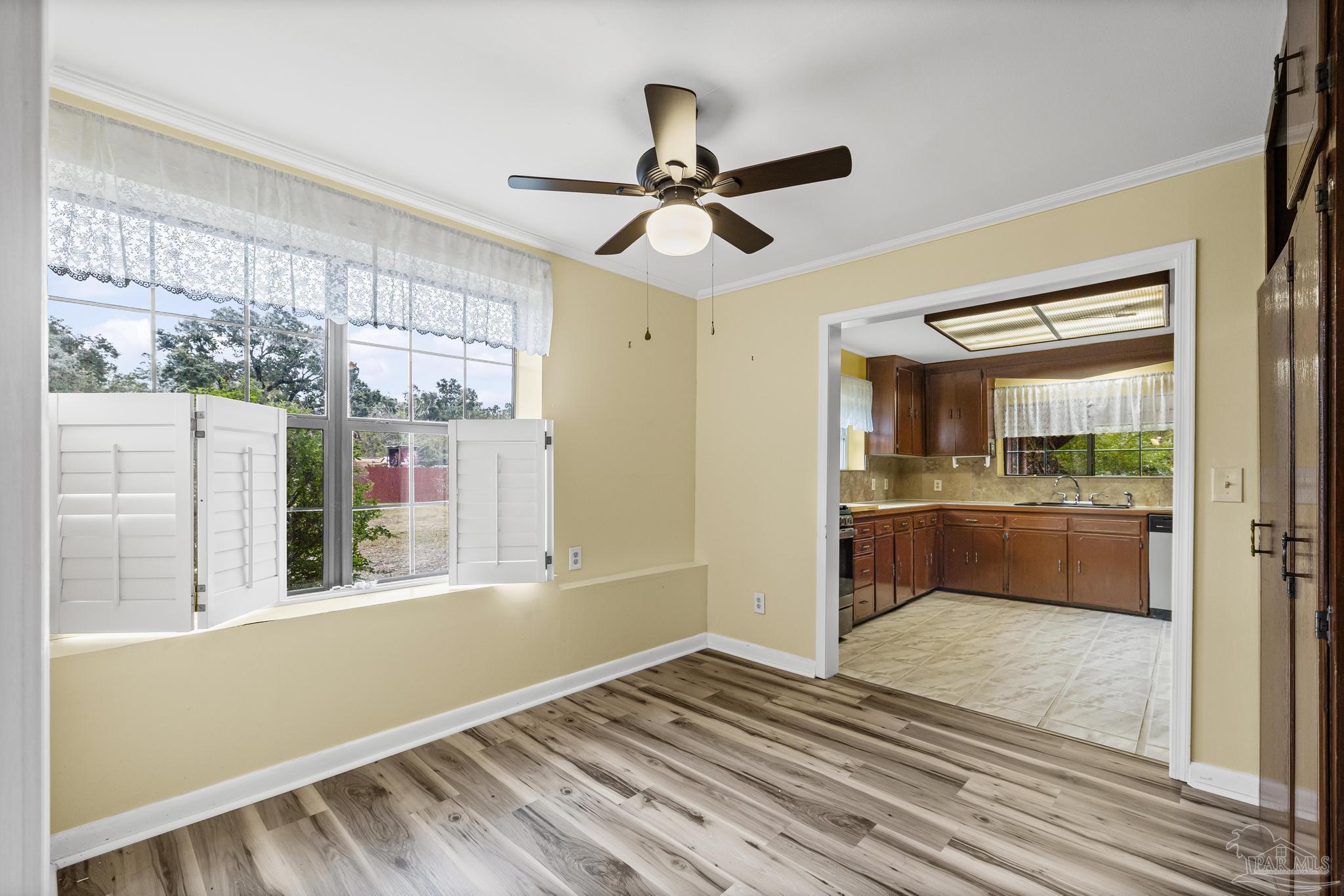 3811 Wilkes Street Pace, FL 32571 - Photo 14 of 59 a view of empty room with wooden floor and fan