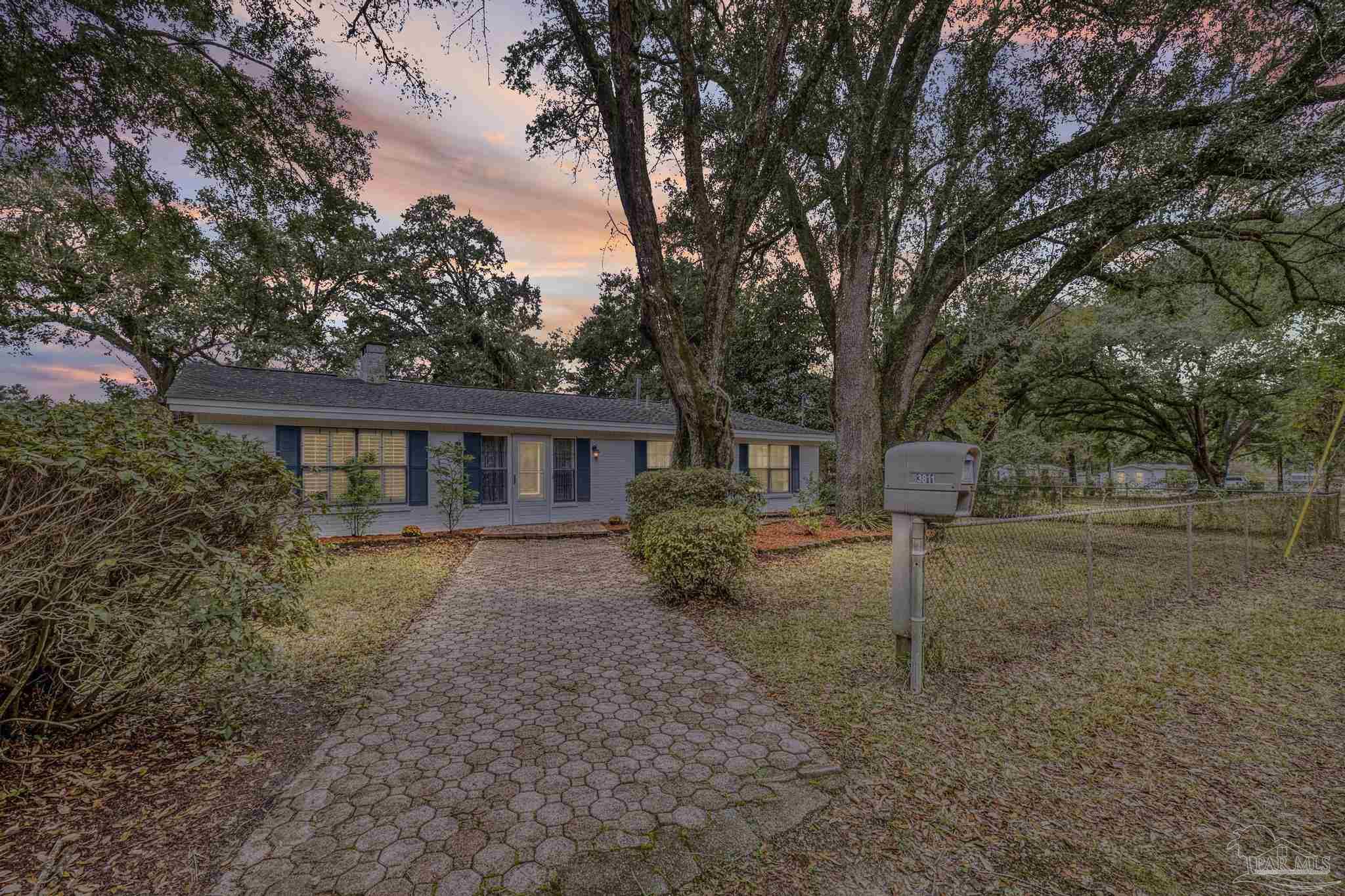 3811 Wilkes Street Pace, FL 32571 - Photo 2 of 59 a view of a yard in front of a house with large trees