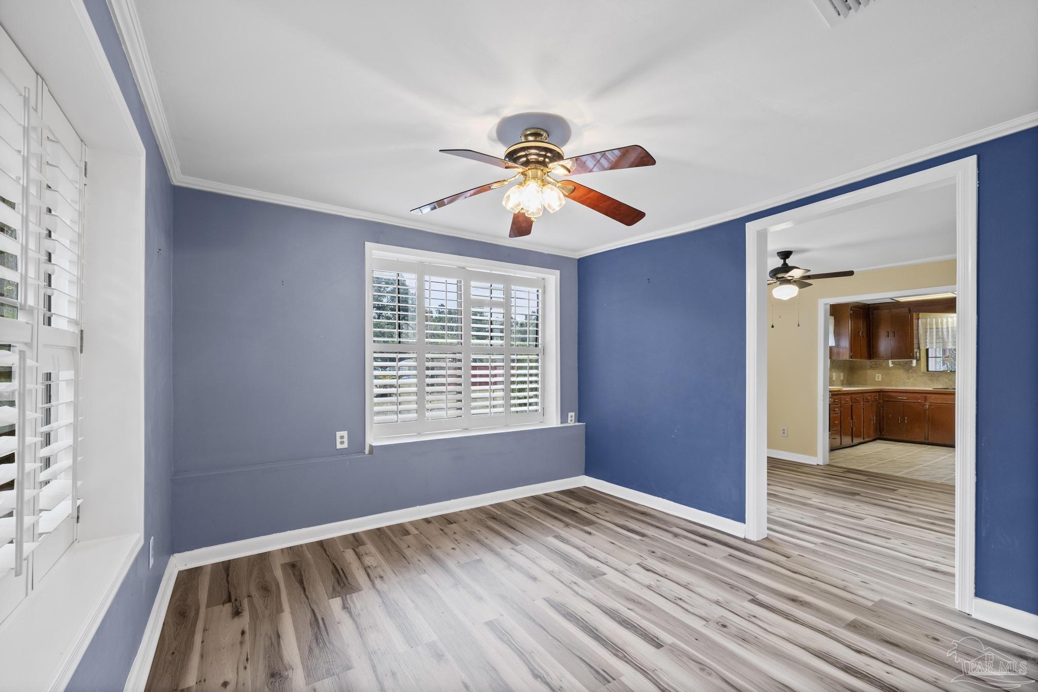 3811 Wilkes Street Pace, FL 32571 - Photo 25 of 59 a view of an empty room with window and wooden floor