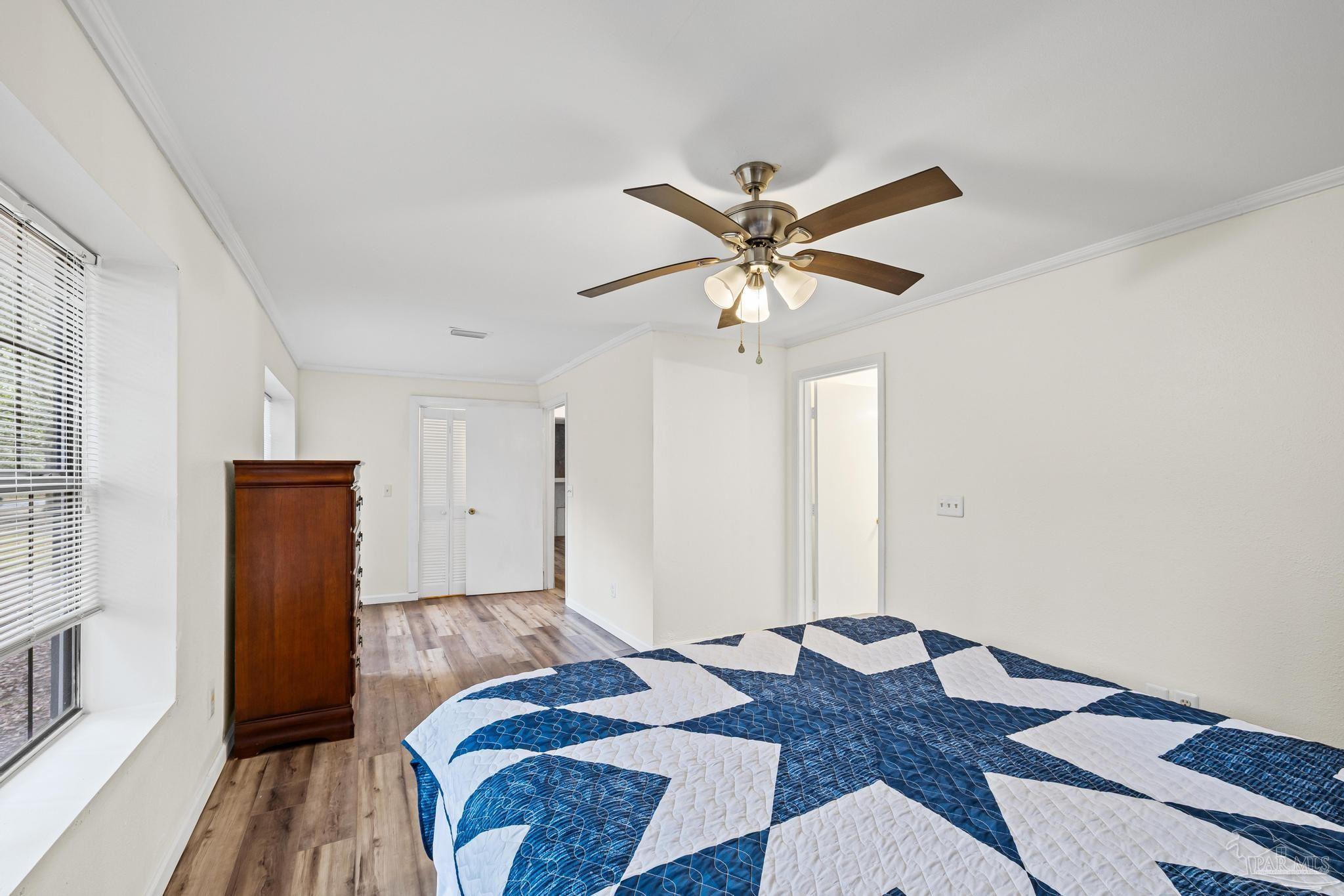 3811 Wilkes Street Pace, FL 32571 - Photo 28 of 59 a bedroom with a bed and a chandelier