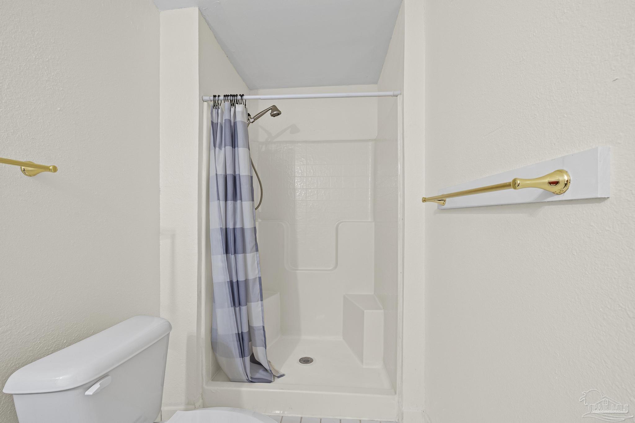 3811 Wilkes Street Pace, FL 32571 - Photo 30 of 59 a bathroom with a shower and toilet