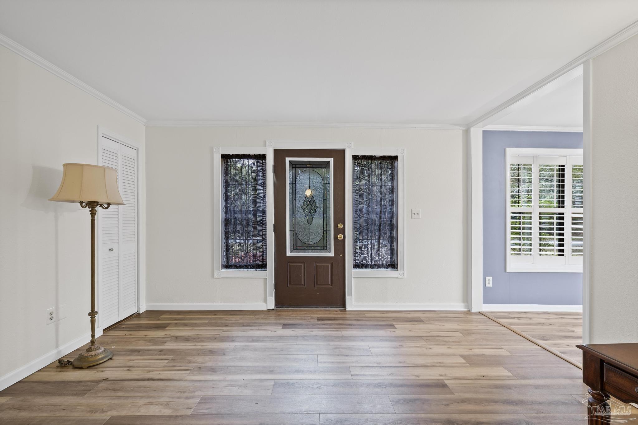 3811 Wilkes Street Pace, FL 32571 - Photo 3 of 59 a view of an empty room with wooden floor and a window