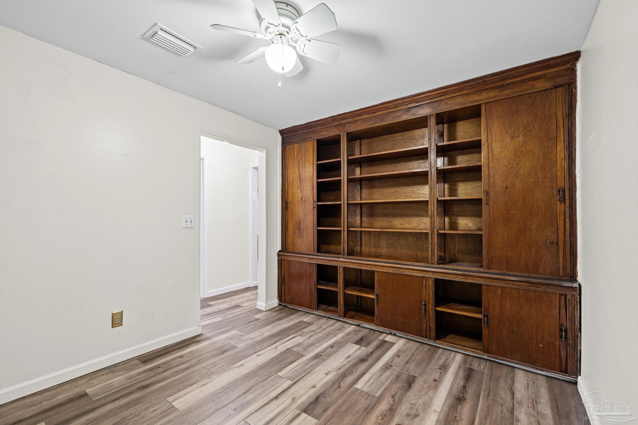 3811 Wilkes Street Pace, FL 32571 - Photo 32 of 59 a view of an empty room with a window and wooden floor