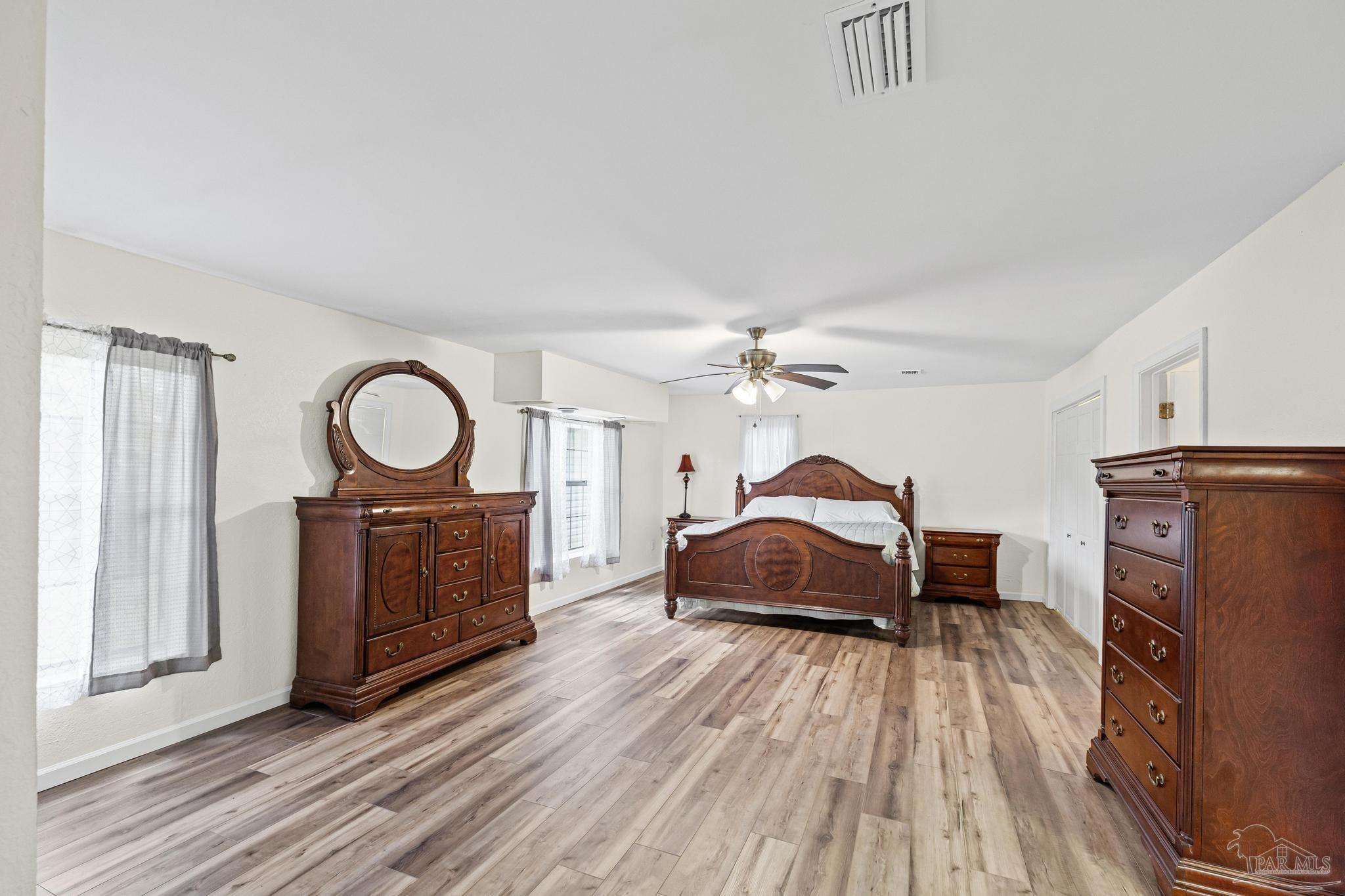3811 Wilkes Street Pace, FL 32571 - Photo 33 of 59 a living room with furniture a fireplace and a flat tv screen on dresser