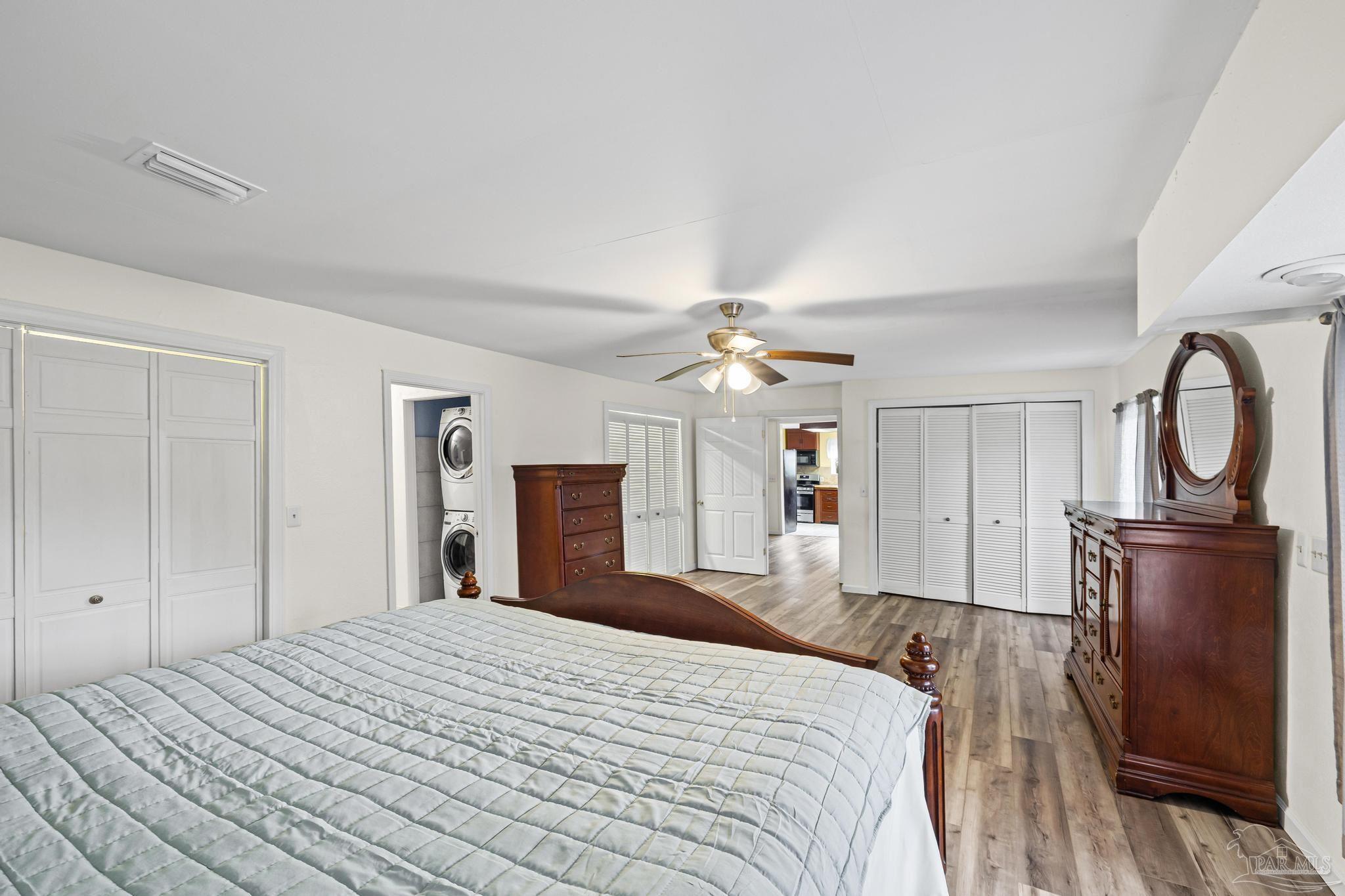 3811 Wilkes Street Pace, FL 32571 - Photo 34 of 59 a bedroom with a bed and dresser with mirror