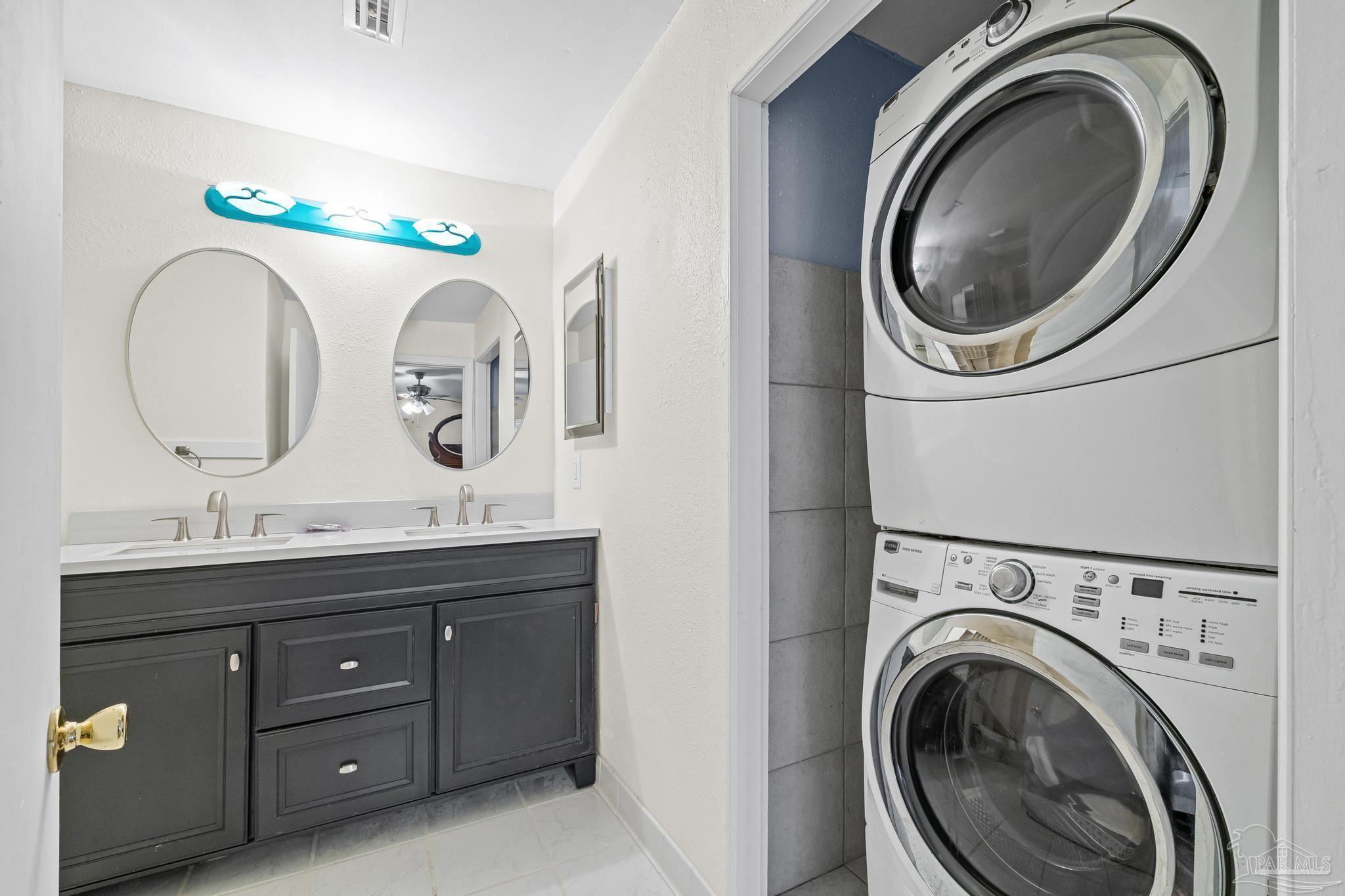 3811 Wilkes Street Pace, FL 32571 - Photo 36 of 59 a bathroom with a granite countertop double vanity sink and a mirror