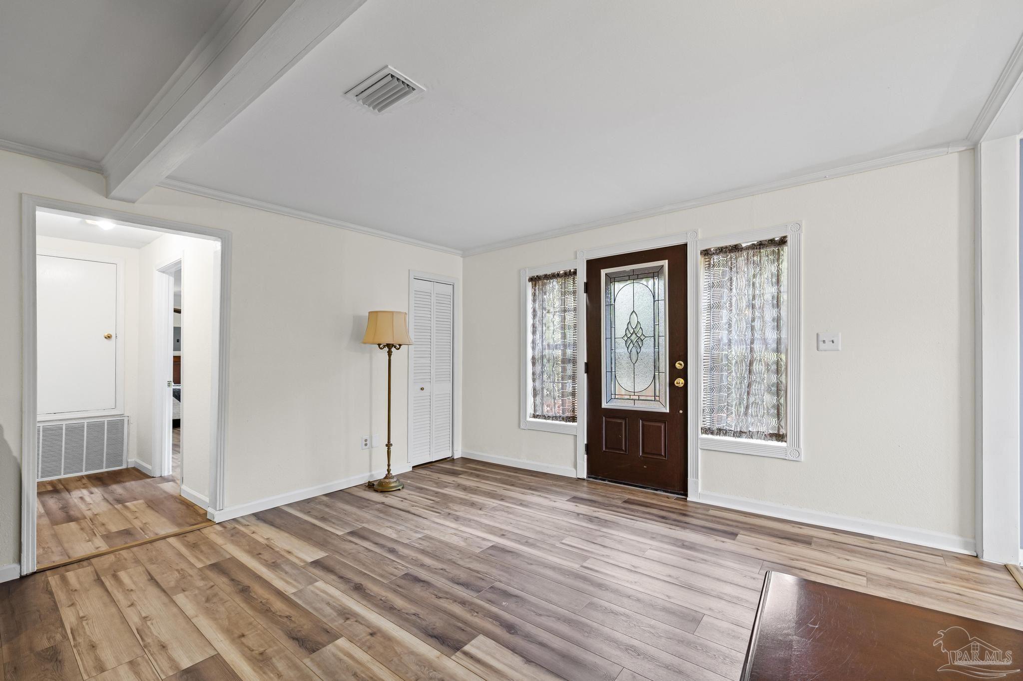 3811 Wilkes Street Pace, FL 32571 - Photo 4 of 59 a bedroom with a bed and wooden floor