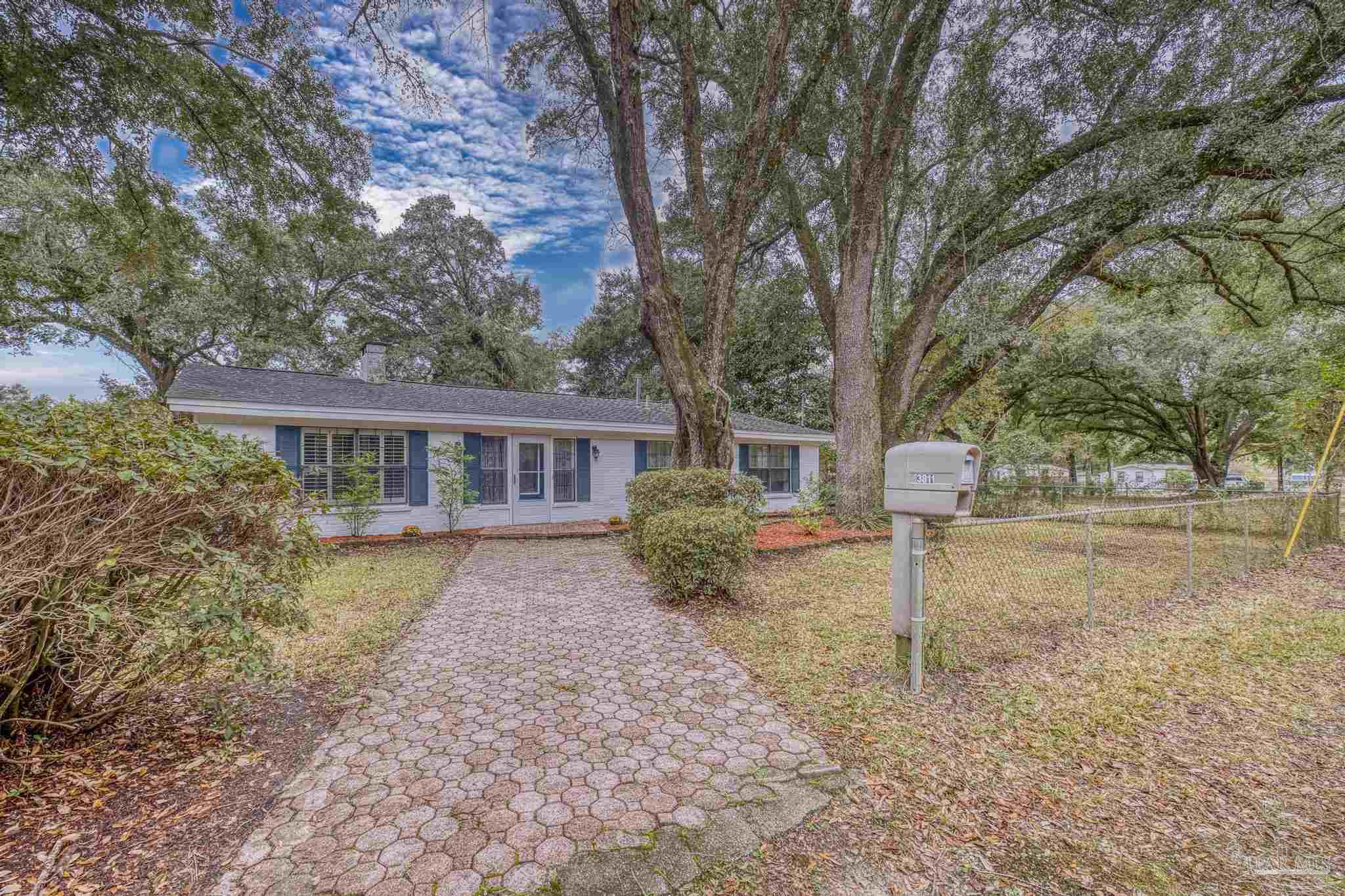 3811 Wilkes Street Pace, FL 32571 - Photo 44 of 59 a front view of a house with garden