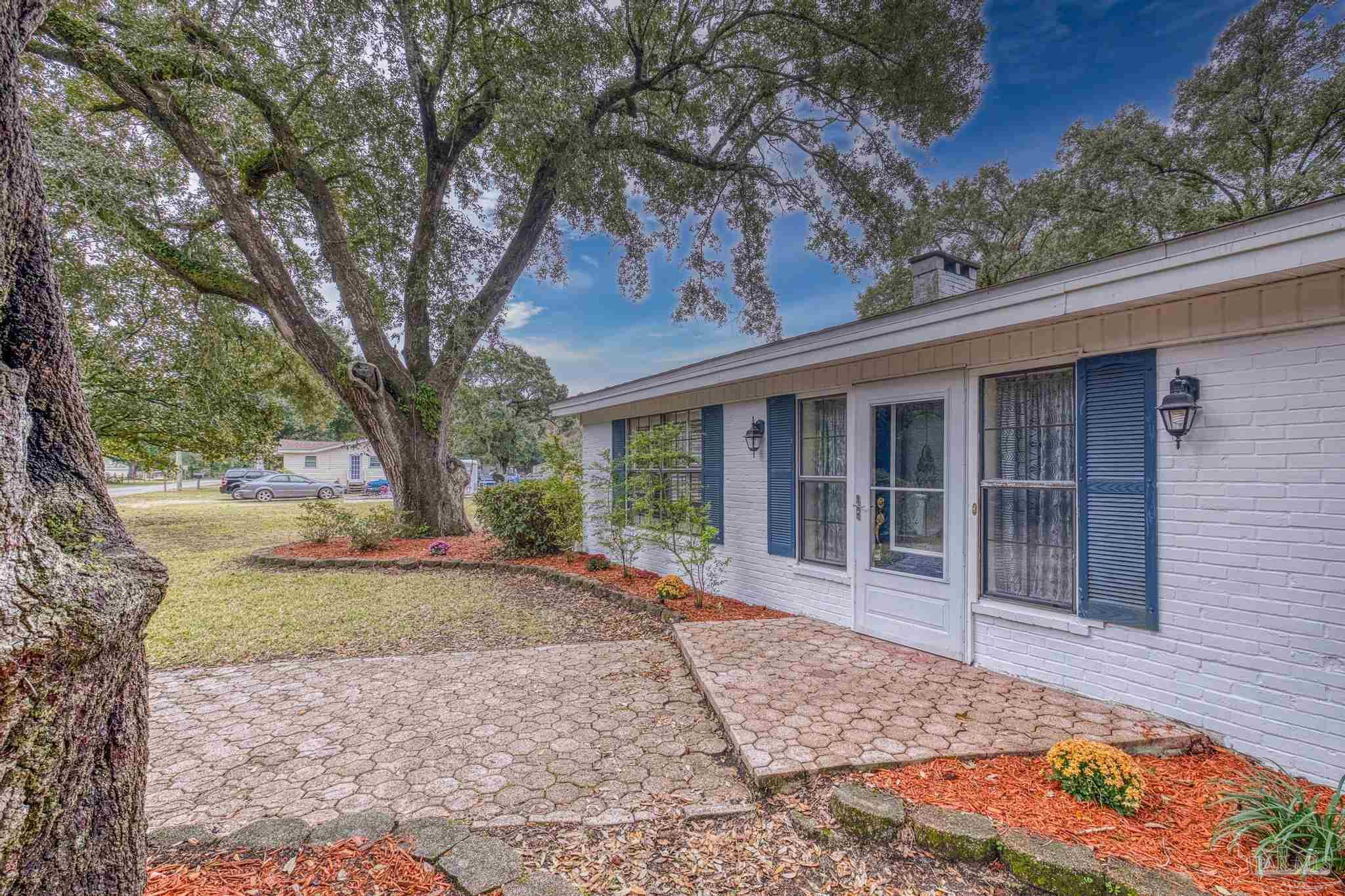 3811 Wilkes Street Pace, FL 32571 - Photo 46 of 59 a view of a house with a garden