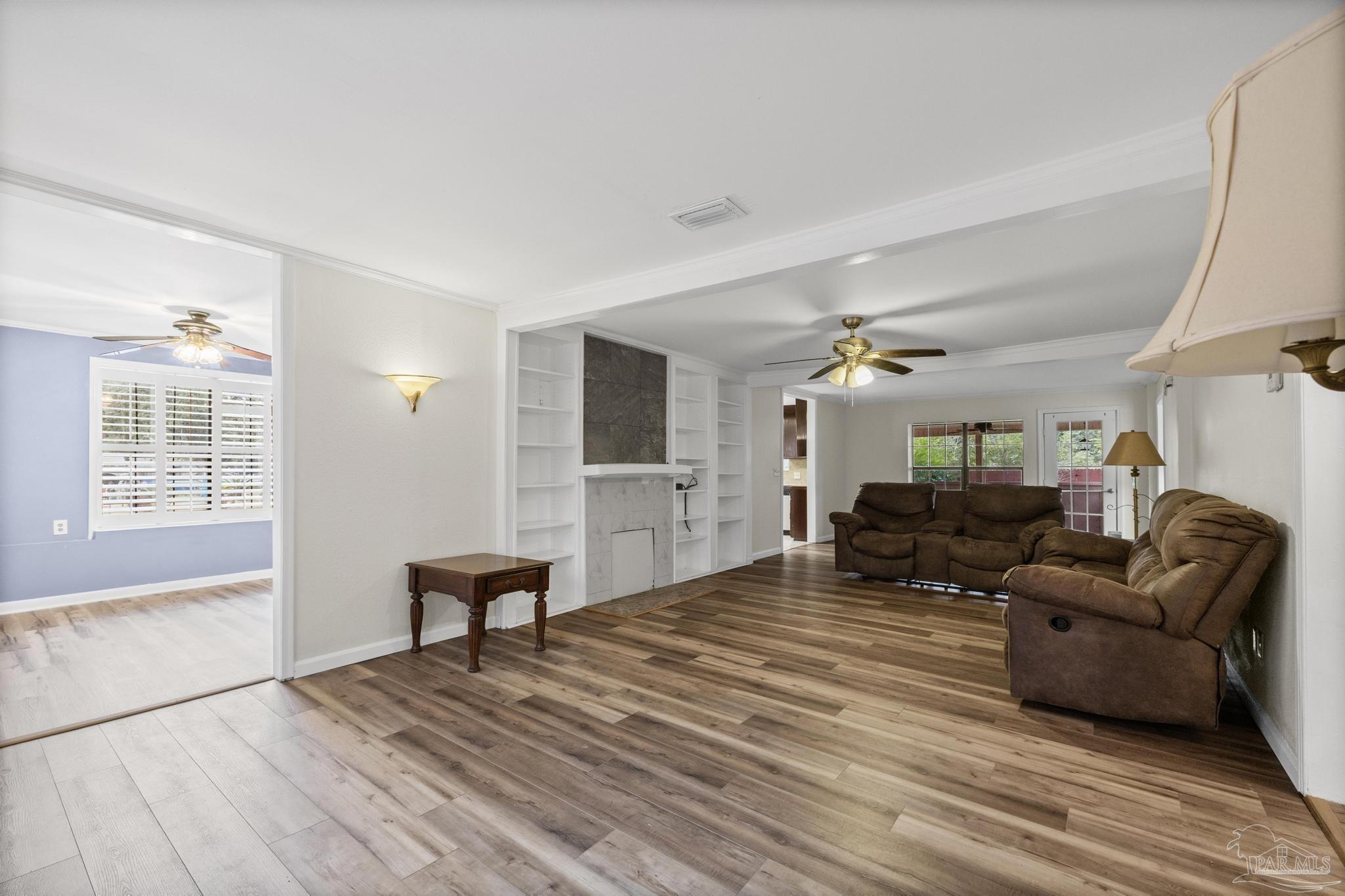 3811 Wilkes Street Pace, FL 32571 - Photo 5 of 59 a living room with furniture and a wooden floor