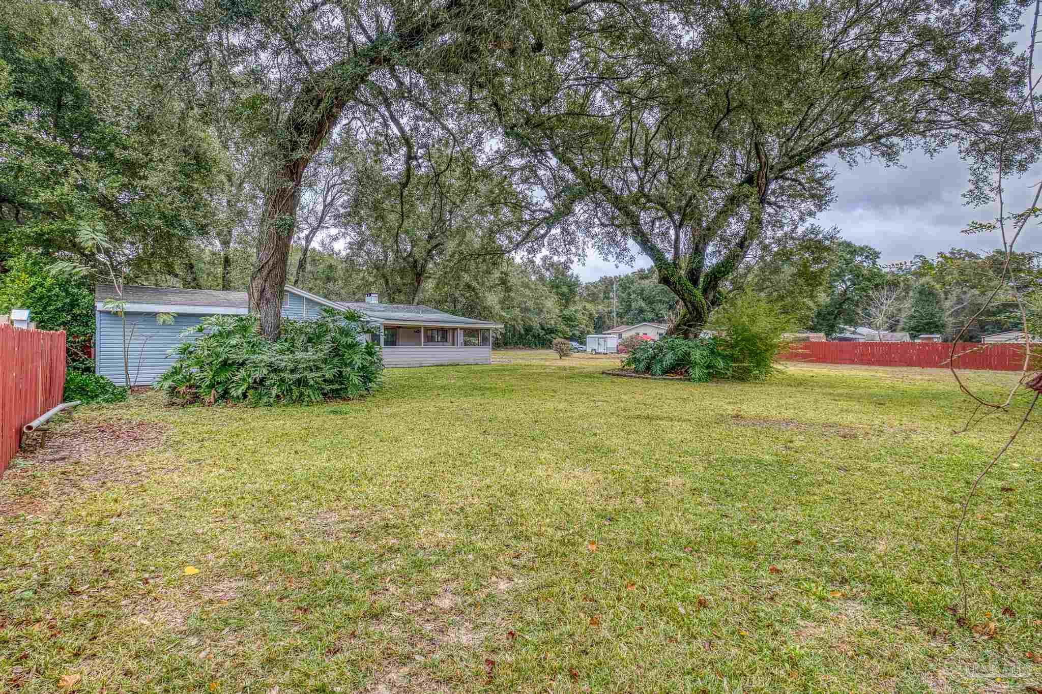3811 Wilkes Street Pace, FL 32571 - Photo 55 of 59 a view of a backyard with a garden