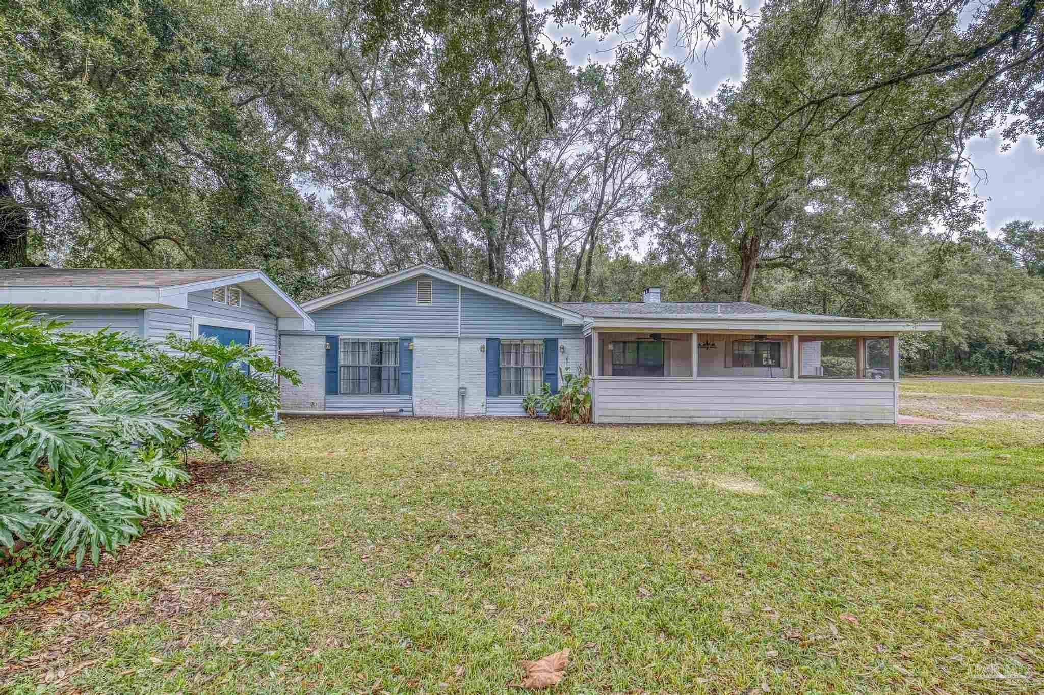 3811 Wilkes Street Pace, FL 32571 - Photo 56 of 59 a front view of a house with yard and green space