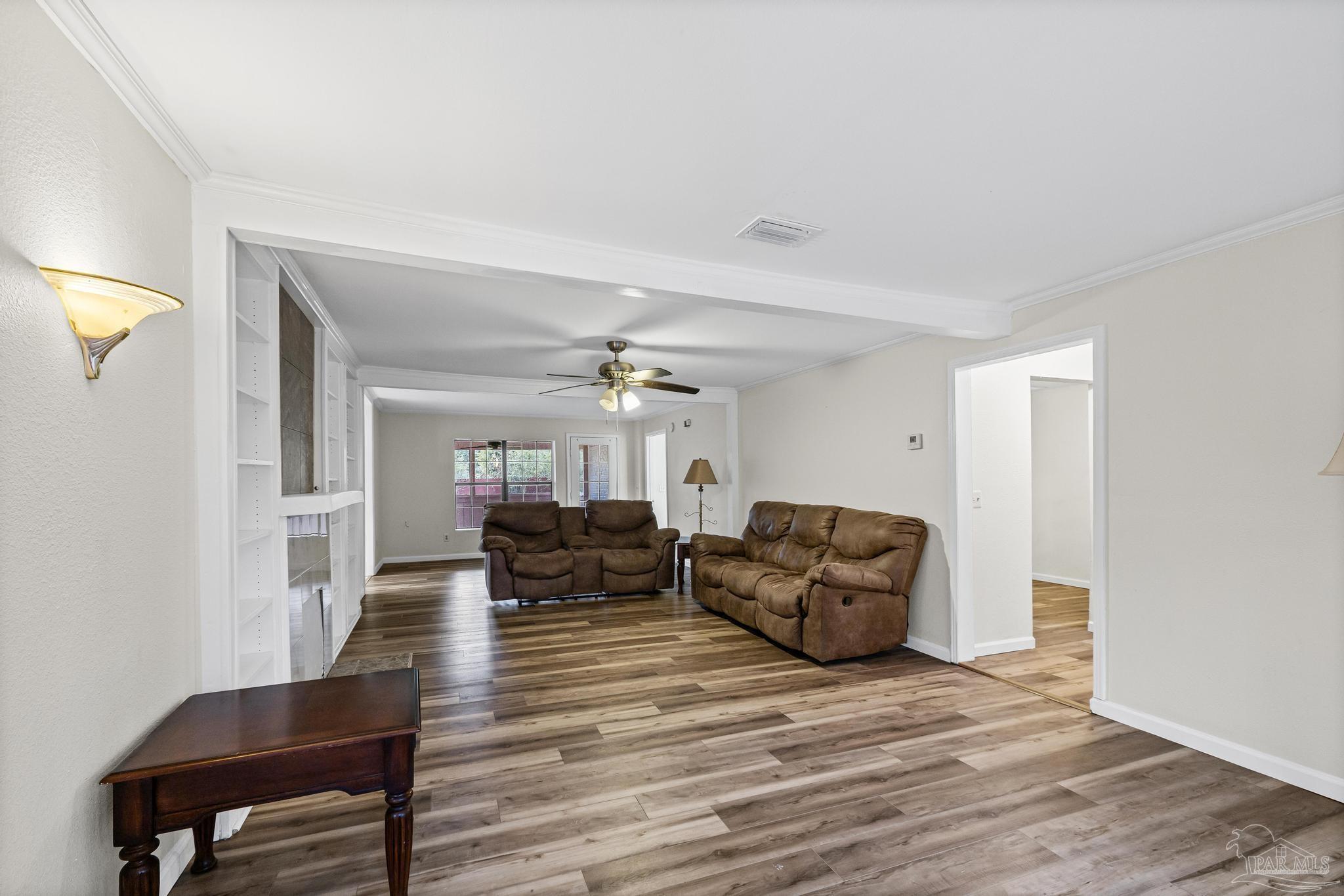 3811 Wilkes Street Pace, FL 32571 - Photo 6 of 59 a living room with furniture and a wooden floor