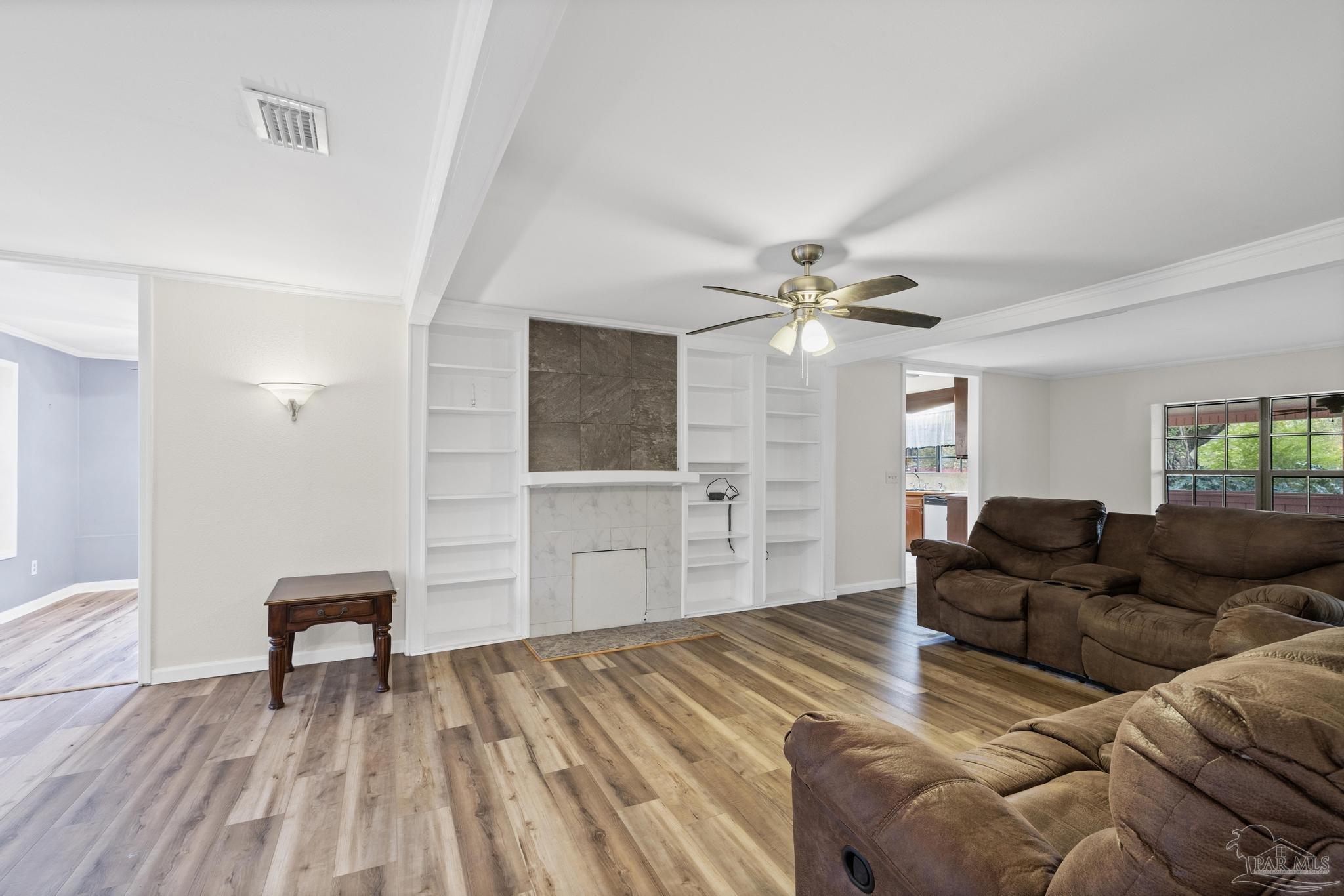 3811 Wilkes Street Pace, FL 32571 - Photo 7 of 59 a living room with furniture and a wooden floor