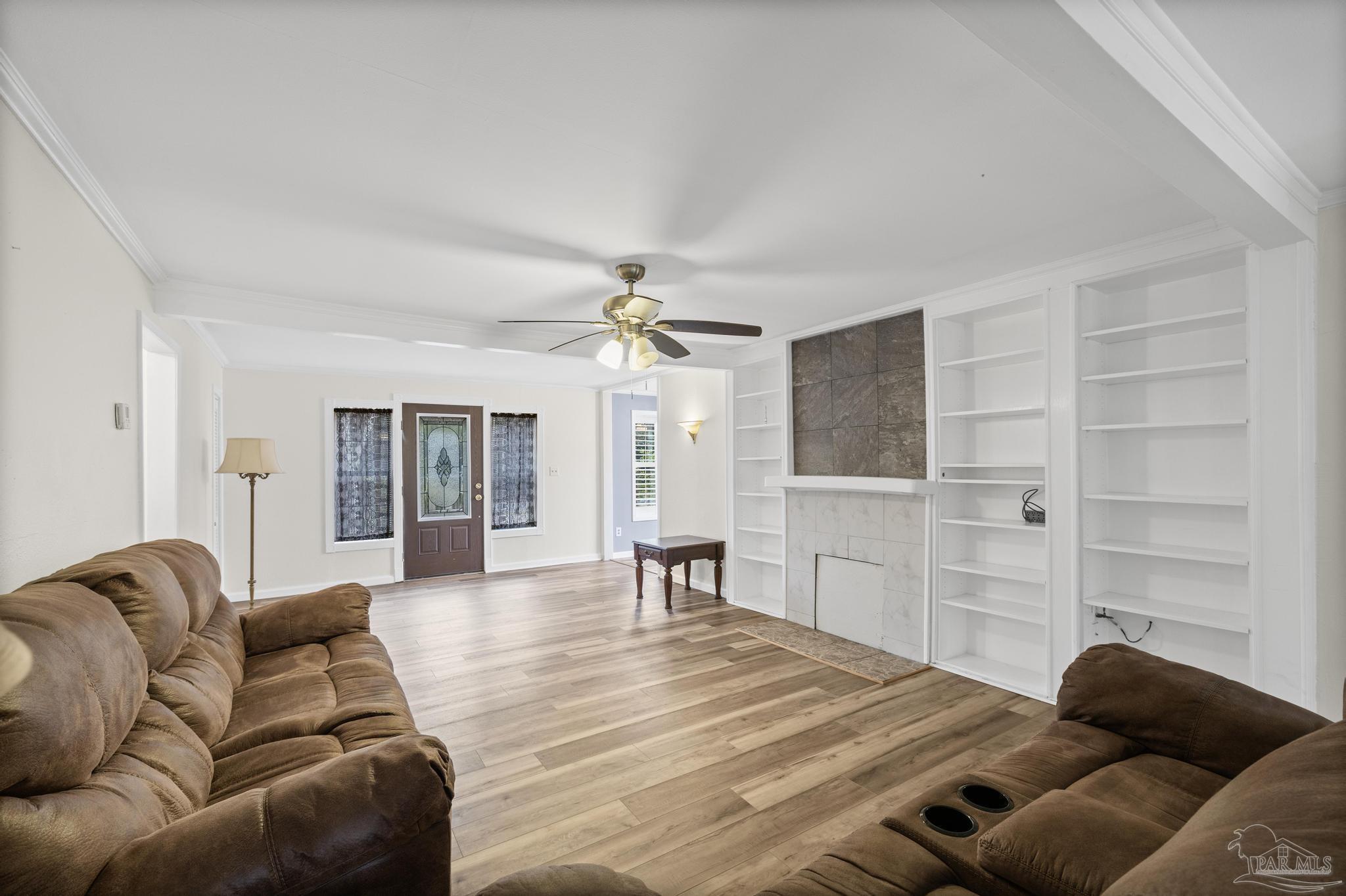 3811 Wilkes Street Pace, FL 32571 - Photo 9 of 59 a living room with furniture and a chandelier