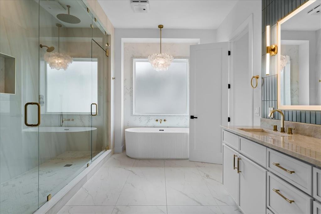 10576 Buccaneer Point Frisco, TX 75036 - Photo 23 of 40 a bathroom with a granite countertop bathtub shower sink and mirror