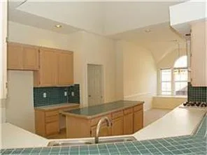a kitchen with sink and cabinets