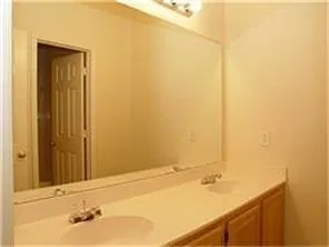 a bathroom with a tub shower and sink