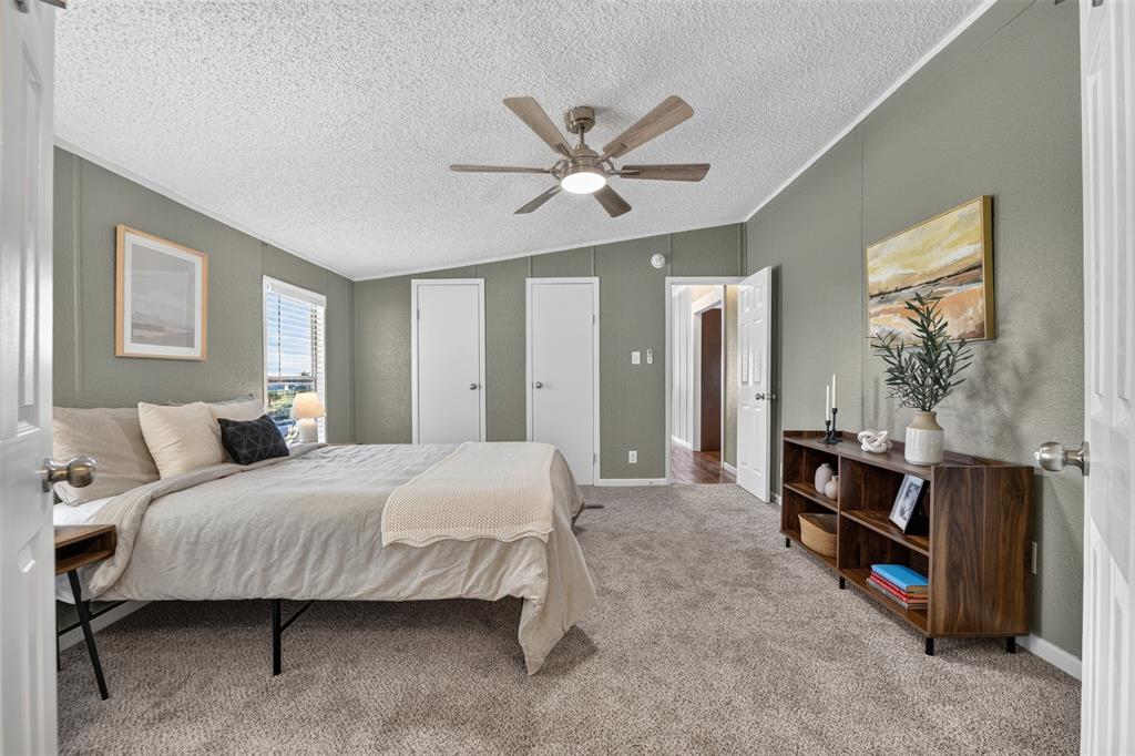 449 Big Salty Lane Springtown, TX 76082 - Photo 17 of 25 Carpeted room with a ceiling fan, sloped ceiling, and multiple white panel doors