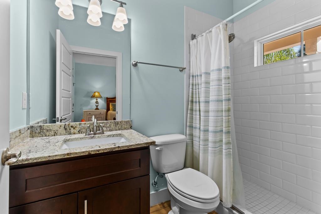 311 E Street St. Augustine, FL 32080 - Photo 16 of 39 a bathroom with a granite countertop toilet sink and mirror