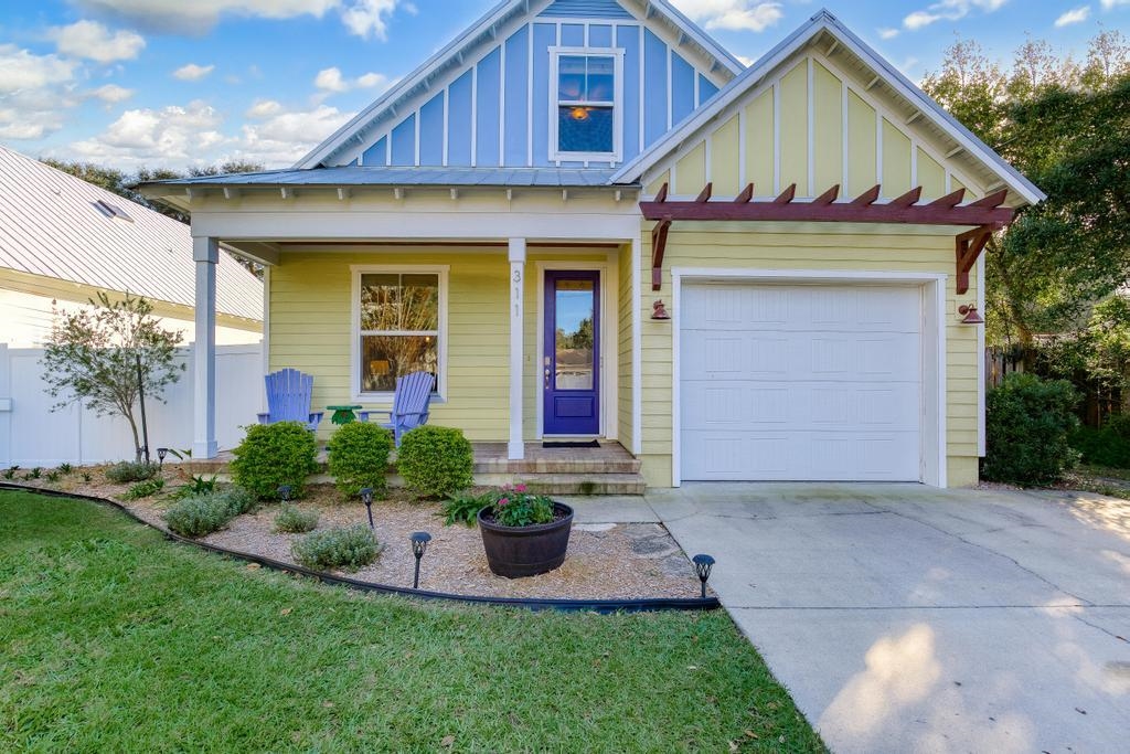 311 E Street St. Augustine, FL 32080 - Photo 4 of 39 a front view of a house with a yard and garage