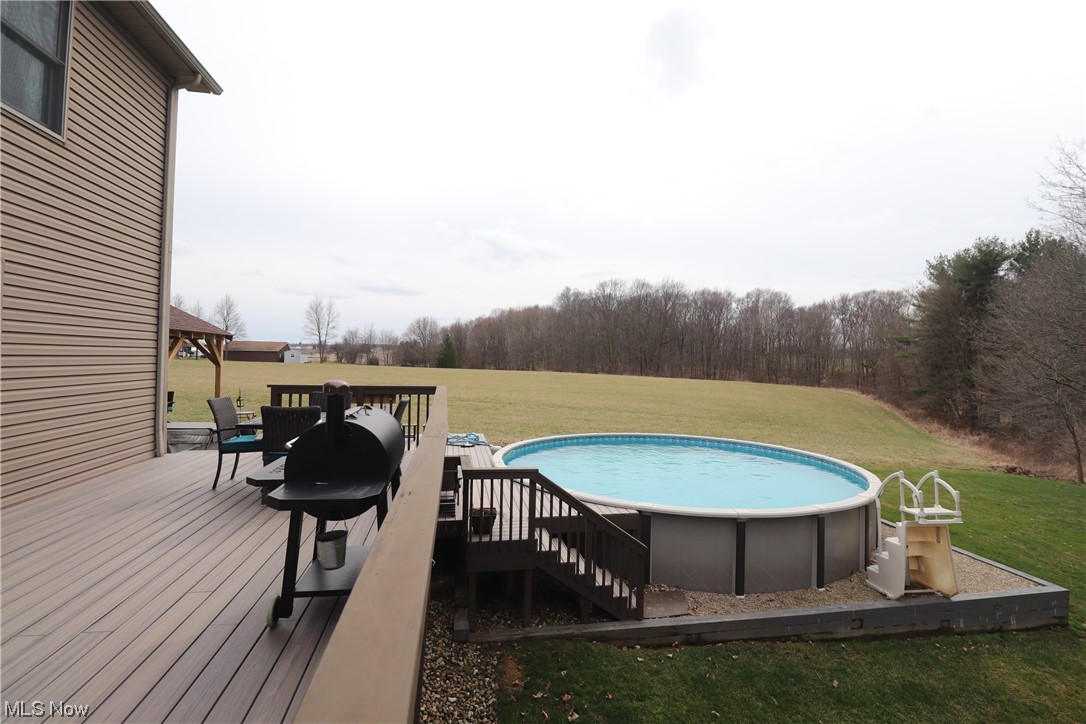 10582 Irvin Road Creston, OH 44217 - Photo 5 of 47 View of swimming pool featuring a deck and a lawn