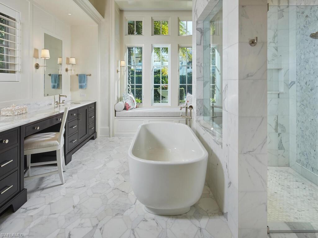167 4th Street North Naples, FL 34102 - Photo 11 of 33 a spacious bathroom with a tub sink and mirror