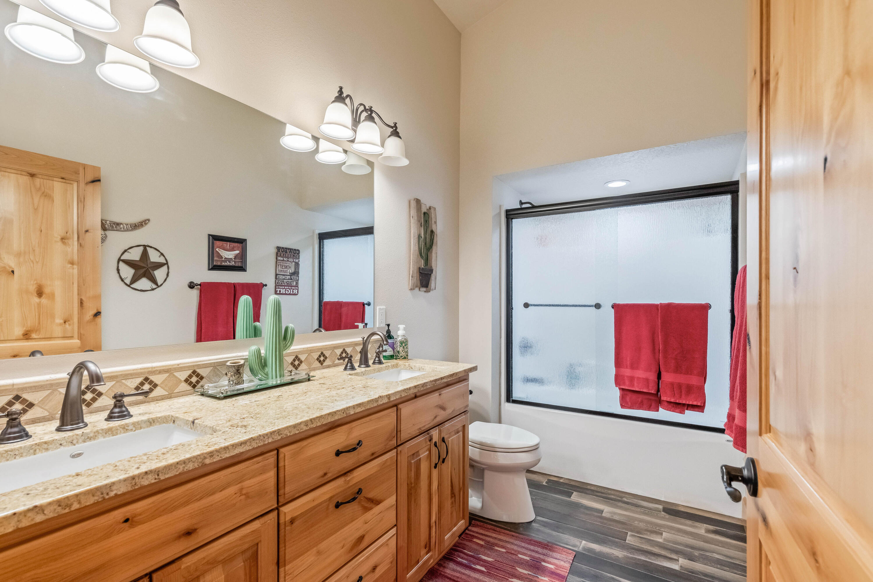 70030 Northwest Hunt Road Sisters, OR 97759 - Photo 19 of 55 a bathroom with a double vanity sink mirror and toilet