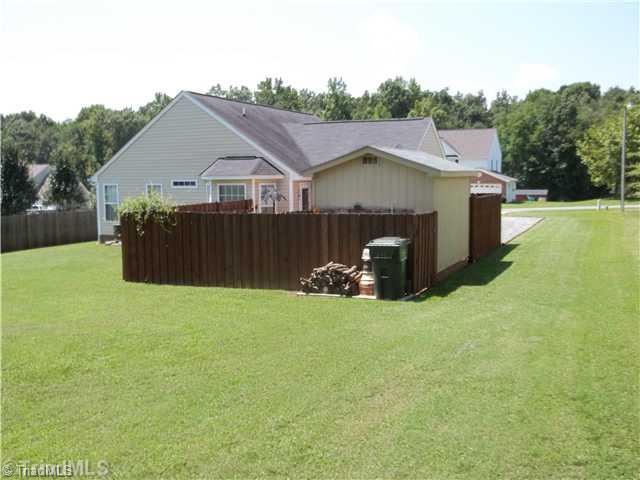 203 Falcon Road Gibsonville, NC 27249 - Photo 14 of 16 Exterior Back. Back view with additional fenced storage area behind building.