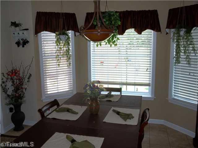 203 Falcon Road Gibsonville, NC 27249 - Photo 5 of 16 Dining Room. Dining Area with Bay Window and Tile flooring and entrance to back patio.