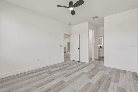 a view of a room with wooden floor closet and windows