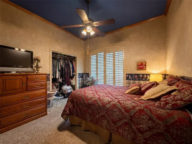 a bedroom with a bed and flat screen tv