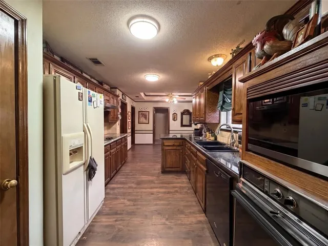 a kitchen with stainless steel appliances sink stove microwave and cabinets