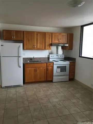 a kitchen with a stove a sink dishwasher and a refrigerator