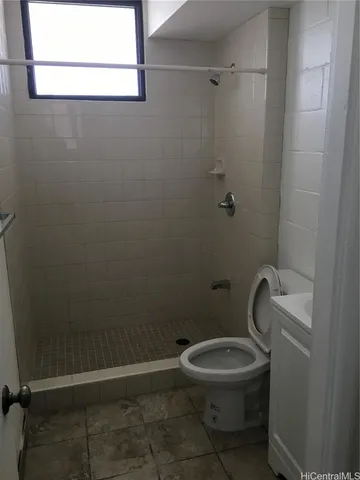a white toilet and a shower in a bathroom