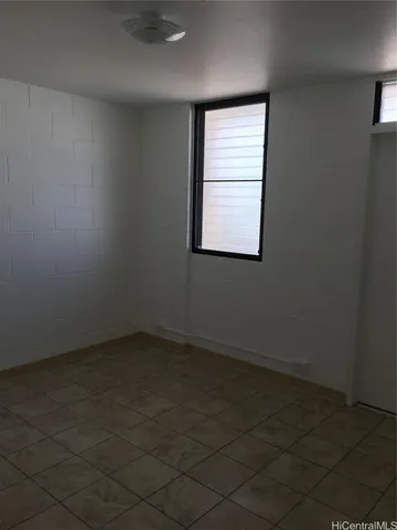 an empty room with a empty space and windows