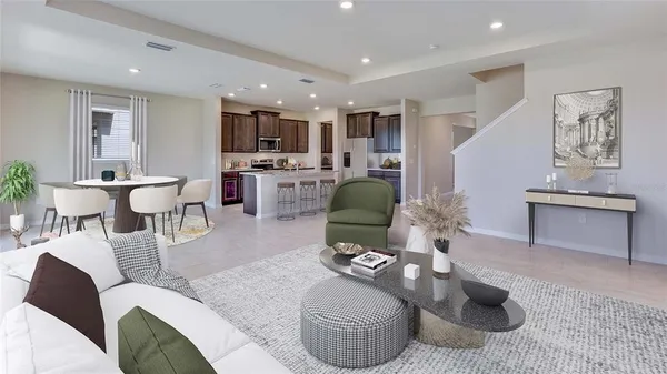 a living room with furniture and a view of kitchen